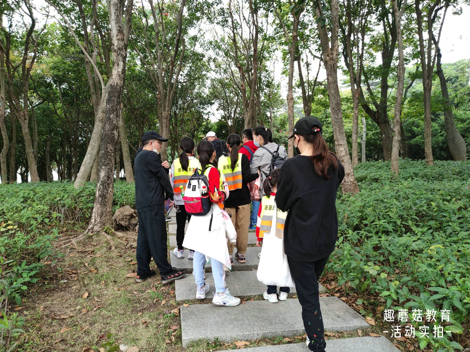 A family group walking through the park
