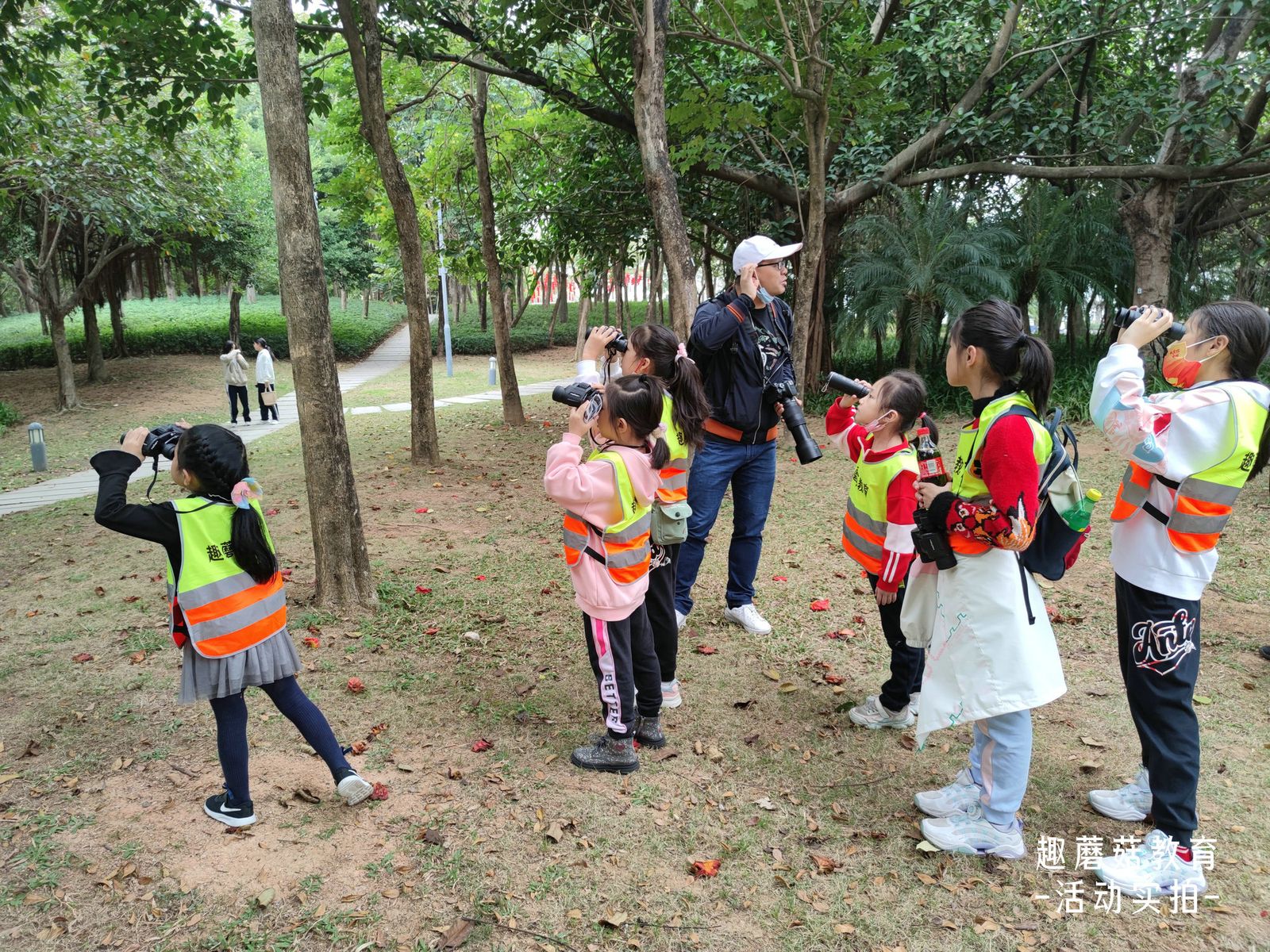 A child scanning the tree line with binoculars