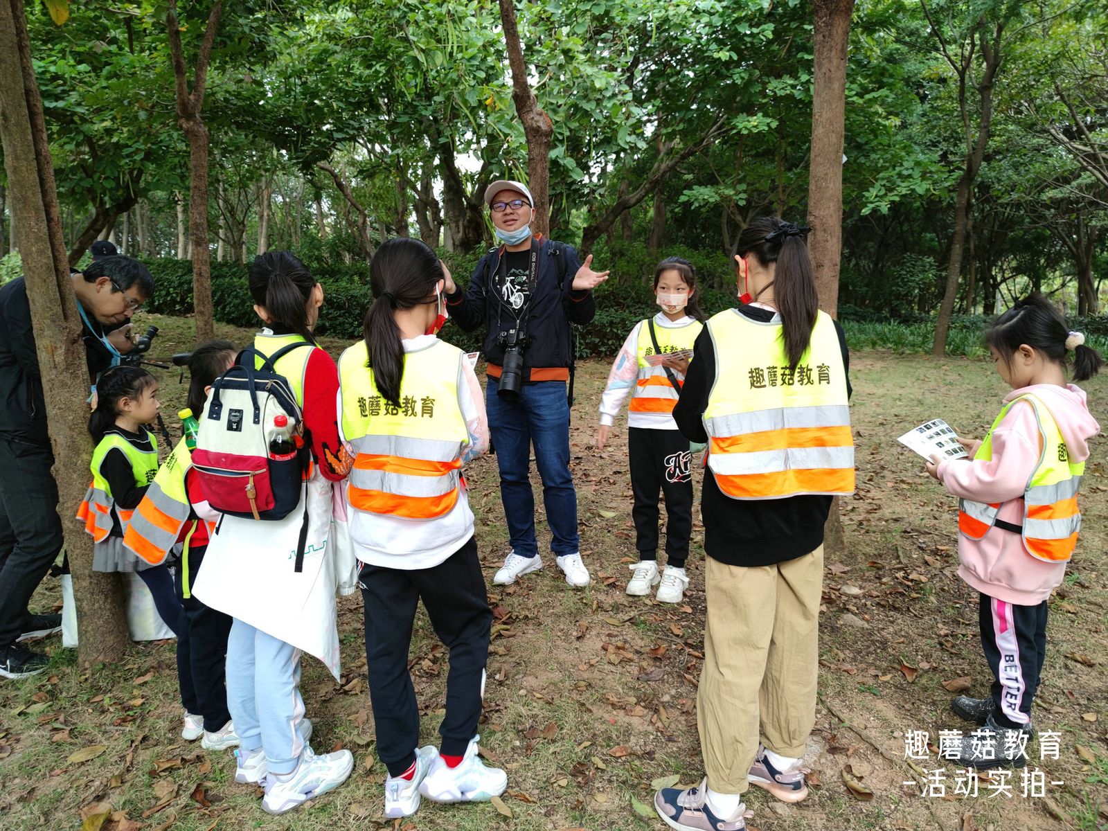 Children lined up on the path, listening to the guide