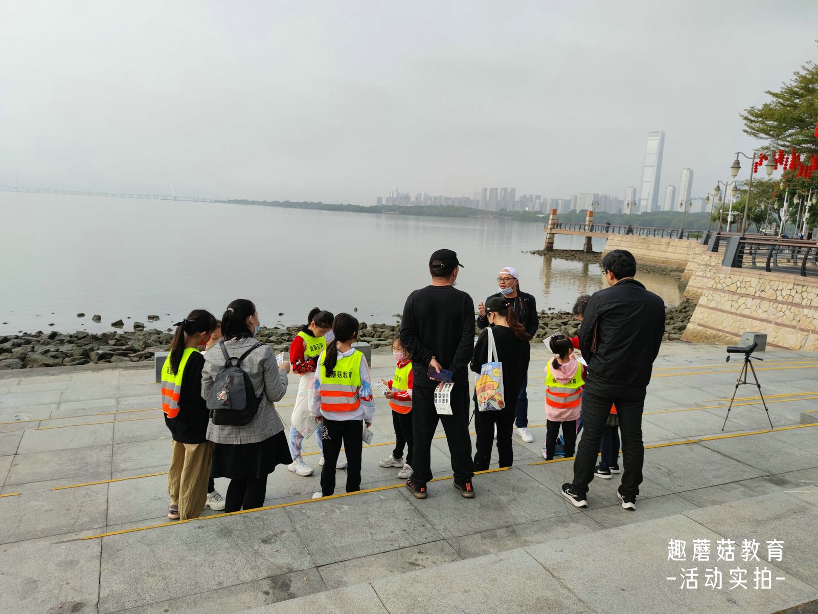 The group on the seawall with binoculars