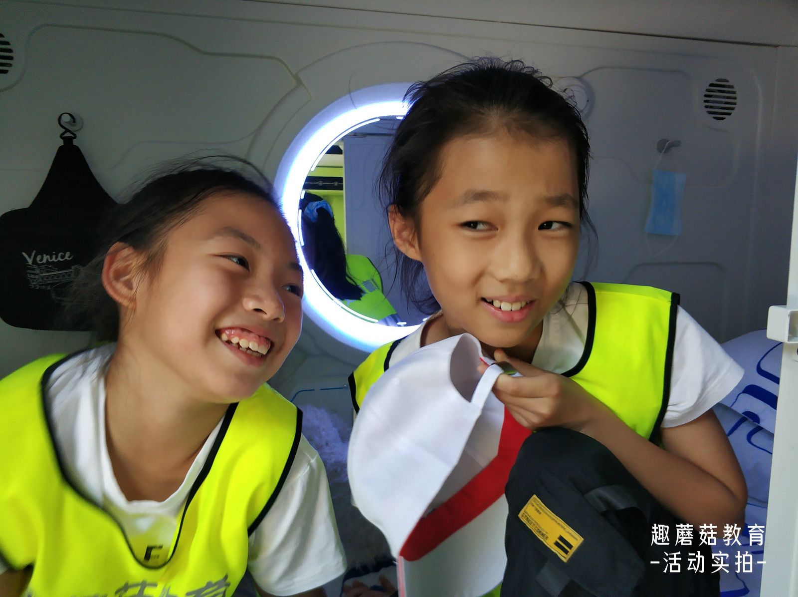 Two girls smiling inside the dorm pod