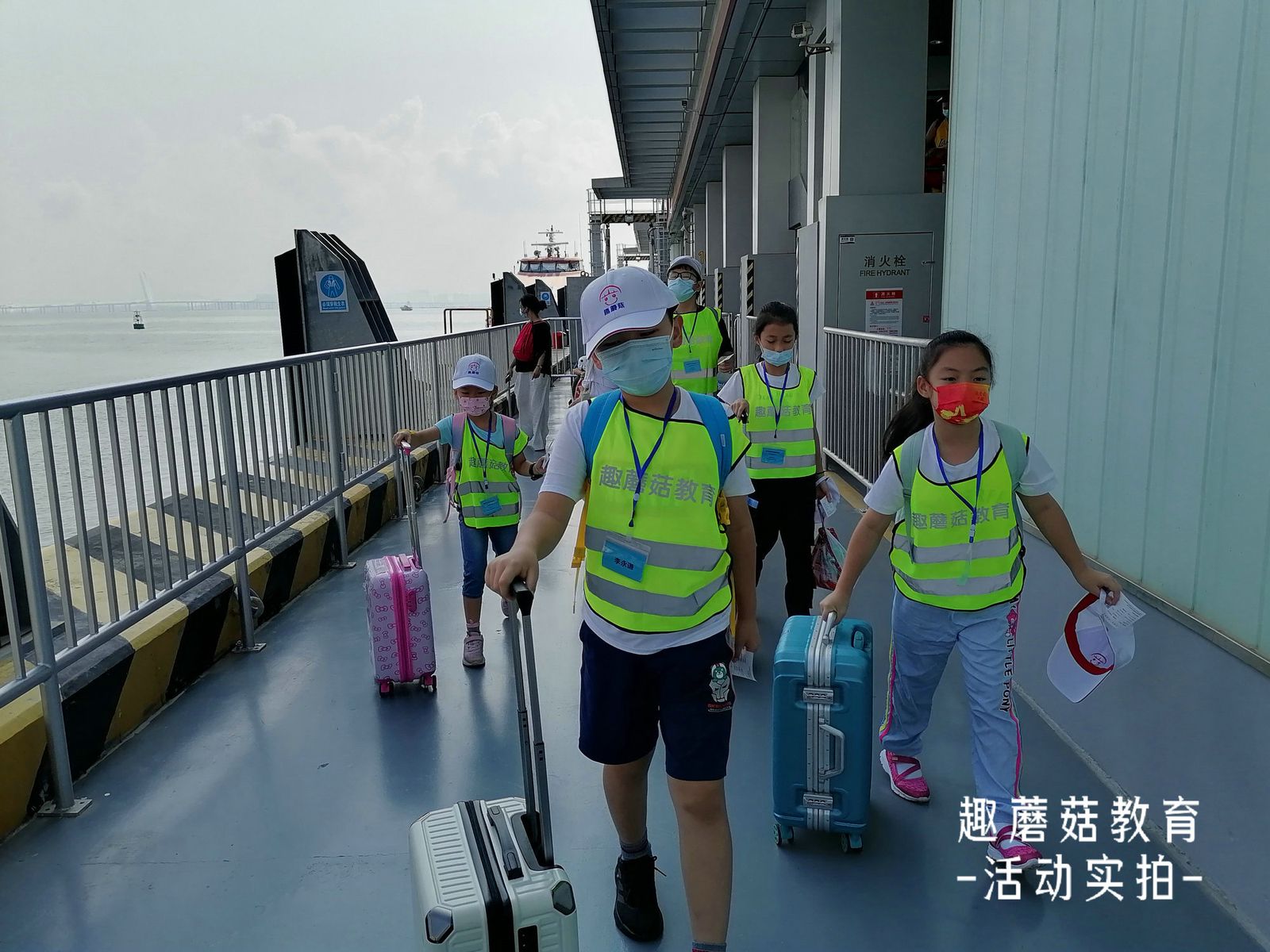 Kids walking up the ferry gangway in vests