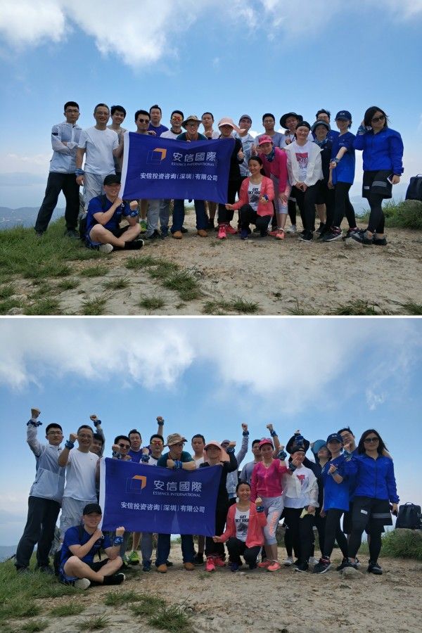 The team on the summit with their banner