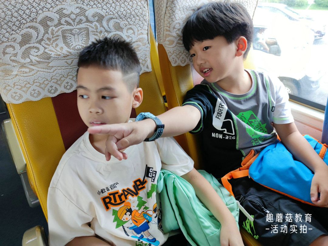Two campers laughing on the bus to camp